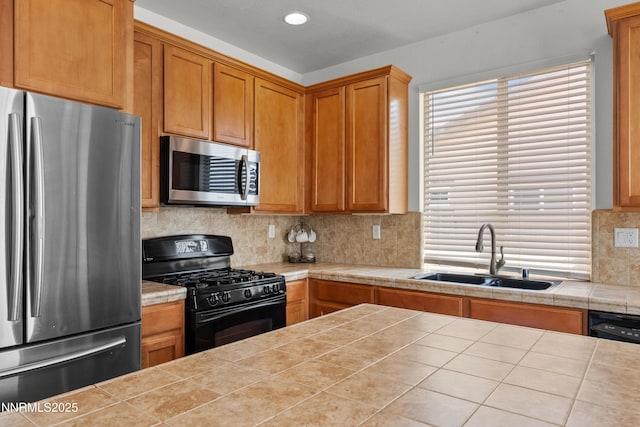 7935 Opal Station Dr, Reno, NV 89506 - kitchen featuring appliances with stainless steel finishes, a sink, backsplash, tile counters, and recessed lighting