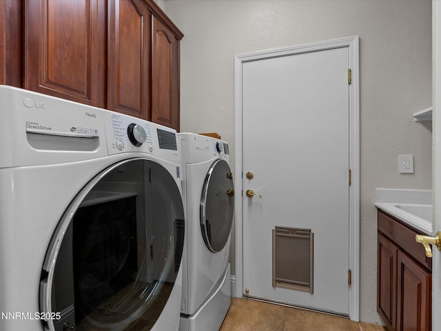 1121 Sageberry Ct, Reno, NV 89509 - laundry area featuring washer and dryer, heating unit, cabinet space, and light tile patterned flooring
