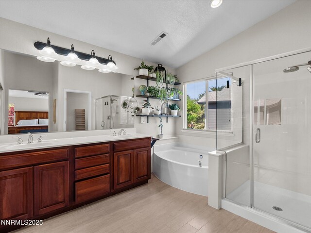 1121 Sageberry Ct, Reno, NV 89509 - ensuite bathroom with a shower stall, wood finished floors, a garden tub, double vanity, and lofted ceiling