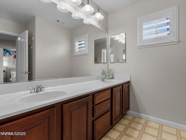 1121 Sageberry Ct, Reno, NV 89509 - bathroom featuring tile patterned floors, double vanity, healthy amount of natural light, and baseboards