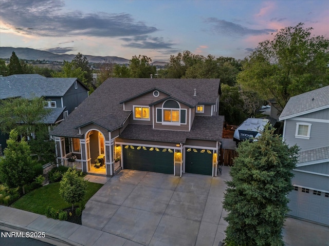 1121 Sageberry Ct, Reno, NV 89509 - view of front of home with concrete driveway, a shingled roof, a garage, covered porch, and a mountain view