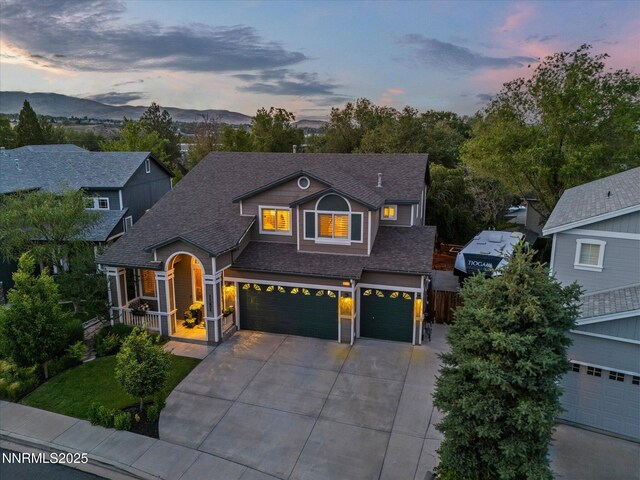 1121 Sageberry Ct, Reno, NV 89509 - view of front of home with concrete driveway, a shingled roof, a garage, covered porch, and a mountain view