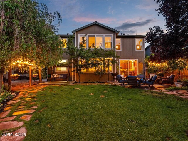 1121 Sageberry Ct, Reno, NV 89509 - rear view of property with a yard, an outdoor living space, and a patio
