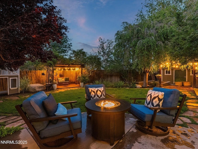 1121 Sageberry Ct, Reno, NV 89509 - patio terrace at dusk with a patio and an outdoor living space with a fire pit