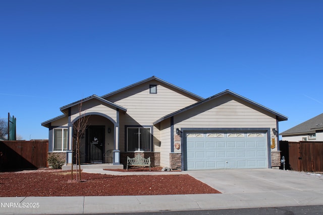 441 Dog Leg Dr, Fernley, NV 89408 - ranch-style house with stone siding, a garage, and driveway