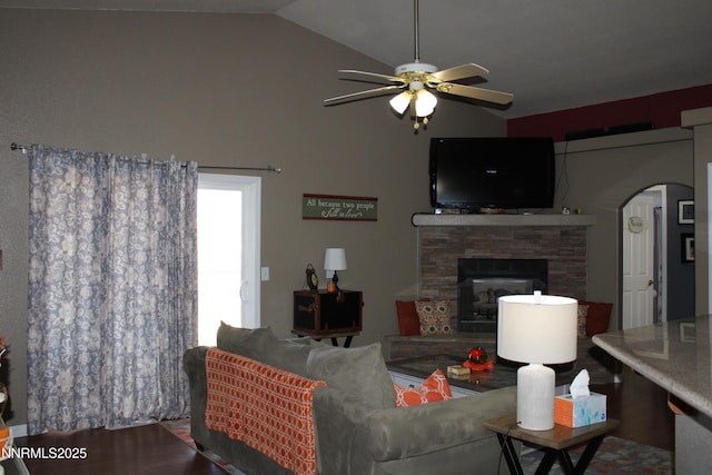 441 Dog Leg Dr, Fernley, NV 89408 - living area with arched walkways, ceiling fan, a stone fireplace, and high vaulted ceiling
