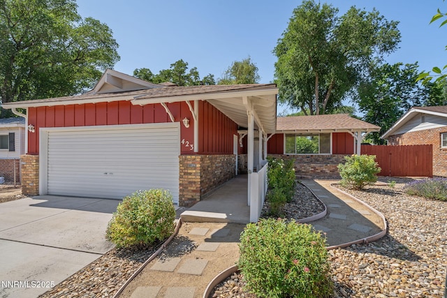 423 Bath St, Carson City, NV 89703 - view of front of property with board and batten siding, a garage, driveway, brick siding, and roof with shingles