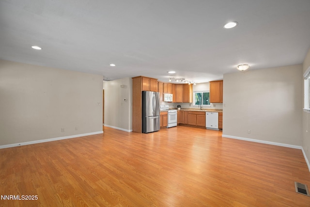 423 Bath St, Carson City, NV 89703 - kitchen featuring white appliances, recessed lighting, light countertops, open floor plan, and light wood finished floors