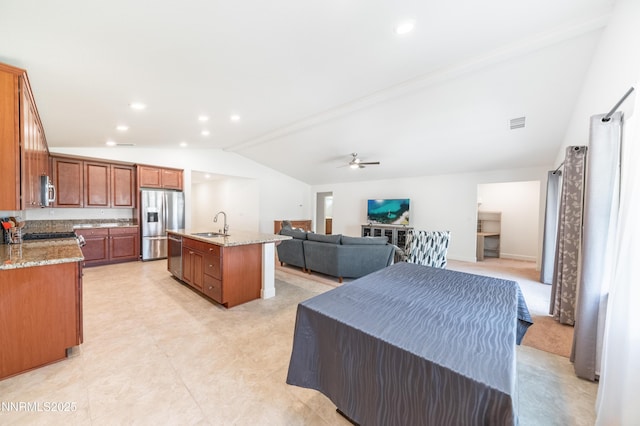 3720 Zoroaster Ct, Sparks, NV 89436 - kitchen with appliances with stainless steel finishes, lofted ceiling, open floor plan, a sink, and a center island with sink