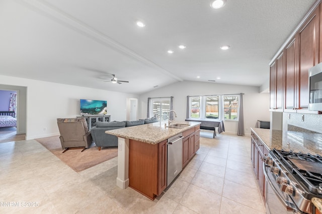 3720 Zoroaster Ct, Sparks, NV 89436 - kitchen with a sink, appliances with stainless steel finishes, vaulted ceiling, light stone counters, and a center island with sink
