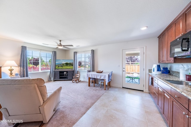 3720 Zoroaster Ct, Sparks, NV 89436 - living area featuring light colored carpet, ceiling fan, light tile patterned floors, and baseboards