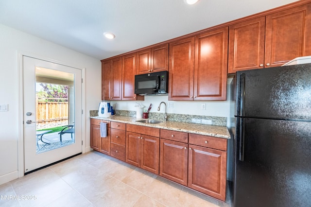 3720 Zoroaster Ct, Sparks, NV 89436 - kitchen featuring black appliances, a sink, light stone countertops, light tile patterned flooring, and brown cabinets