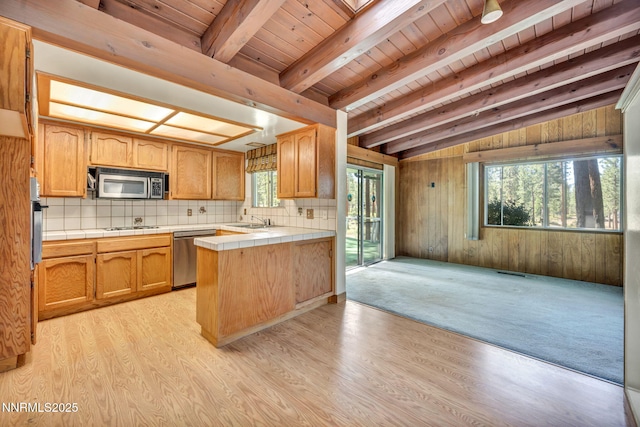 161 Willow Dr, Zephyr Cove, NV 89448 - kitchen with appliances with stainless steel finishes, tile counters, healthy amount of natural light, light wood finished floors, and wooden ceiling