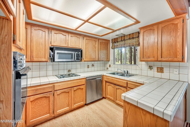 161 Willow Dr, Zephyr Cove, NV 89448 - kitchen with stainless steel appliances, light wood-type flooring, decorative backsplash, and a peninsula