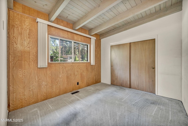 161 Willow Dr, Zephyr Cove, NV 89448 - unfurnished bedroom with carpet, a wood ceiling with exposed beams, a closet, and wooden walls