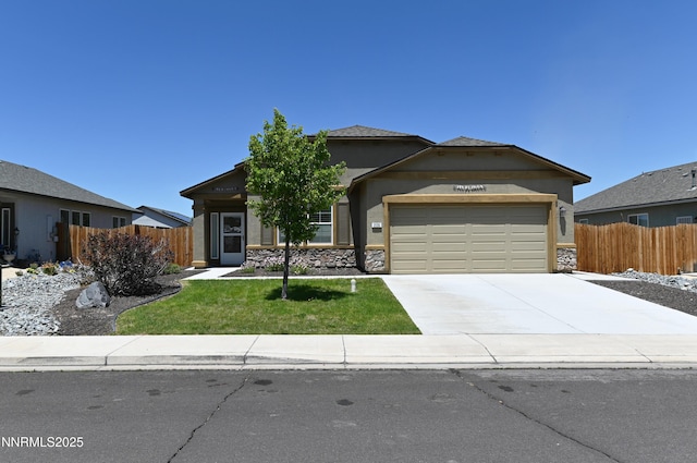 226 Red Oak Dr, Fernley, NV 89408 - view of front of home with an attached garage, stucco siding, driveway, and stone siding