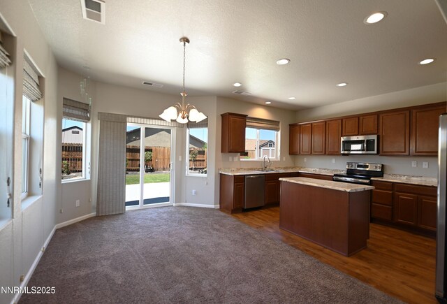 226 Red Oak Dr, Fernley, NV 89408 - kitchen with stainless steel appliances, light countertops, a chandelier, a center island, and recessed lighting