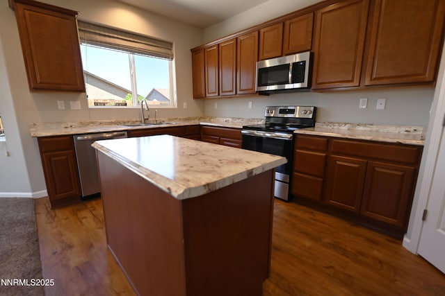 226 Red Oak Dr, Fernley, NV 89408 - kitchen with appliances with stainless steel finishes, dark wood-type flooring, light countertops, a kitchen island, and brown cabinets