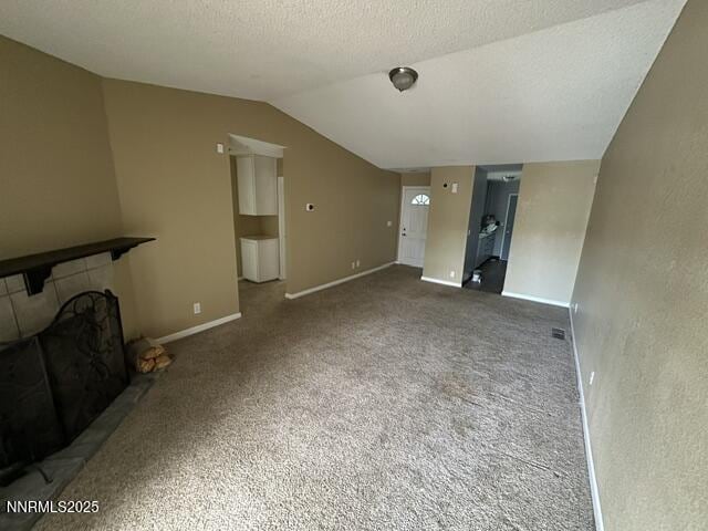 10083 Zeolite Dr, Reno, NV 89506 - unfurnished living room with lofted ceiling, a large fireplace, and carpet