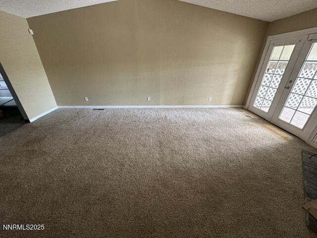 10083 Zeolite Dr, Reno, NV 89506 - carpeted spare room with a textured ceiling and french doors