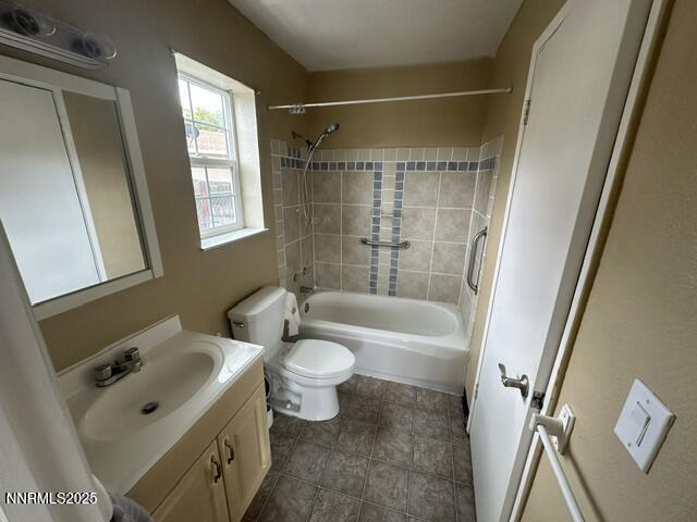 10083 Zeolite Dr, Reno, NV 89506 - bathroom with vanity, shower / bathtub combination, and tile patterned flooring