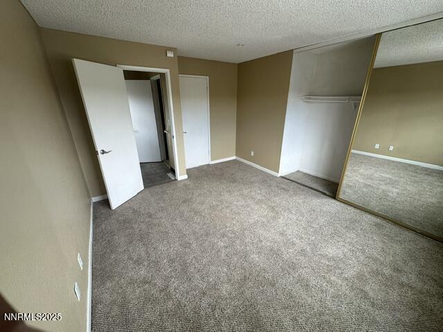 10083 Zeolite Dr, Reno, NV 89506 - unfurnished bedroom with a textured ceiling, carpet flooring, and a closet