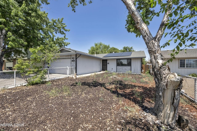 650 E York Way, Sparks, NV 89431 - view of front facade with an attached garage, roof mounted solar panels, and driveway