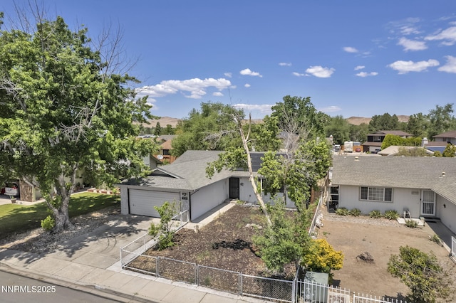 650 E York Way, Sparks, NV 89431 - view of front of property featuring a fenced front yard, concrete driveway, a mountain view, and a garage