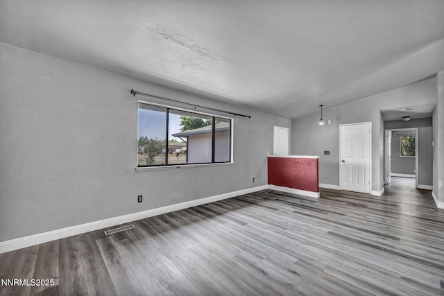 650 E York Way, Sparks, NV 89431 - unfurnished living room featuring plenty of natural light, wood finished floors, and vaulted ceiling