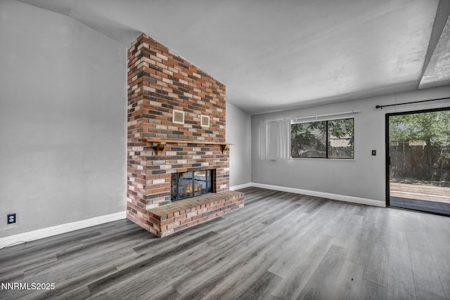 650 E York Way, Sparks, NV 89431 - unfurnished living room featuring wood finished floors and a brick fireplace