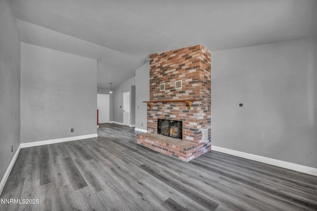 650 E York Way, Sparks, NV 89431 - unfurnished living room featuring wood finished floors, lofted ceiling, and a brick fireplace