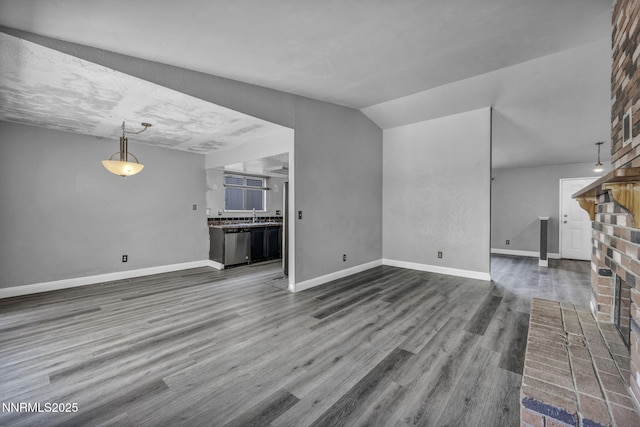650 E York Way, Sparks, NV 89431 - unfurnished living room with dark wood-type flooring and a brick fireplace