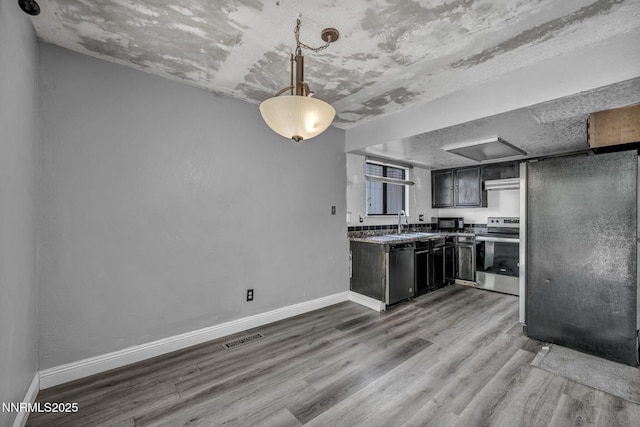 650 E York Way, Sparks, NV 89431 - kitchen with stainless steel range with electric cooktop, dishwashing machine, wood finished floors, black microwave, and extractor fan