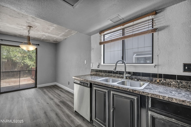 650 E York Way, Sparks, NV 89431 - kitchen featuring stainless steel dishwasher, dark countertops, a textured wall, a textured ceiling, and dark cabinets