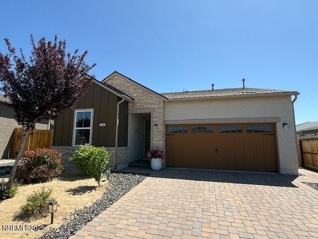 7800 Hoback Dr, Sparks, NV 89436 - single story home with stone siding, an attached garage, decorative driveway, and board and batten siding