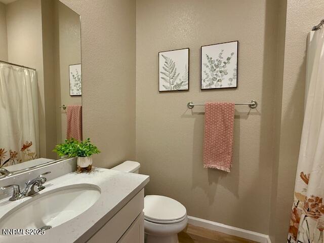 7800 Hoback Dr, Sparks, NV 89436 - bathroom featuring vanity, toilet, curtained shower, and wood finished floors