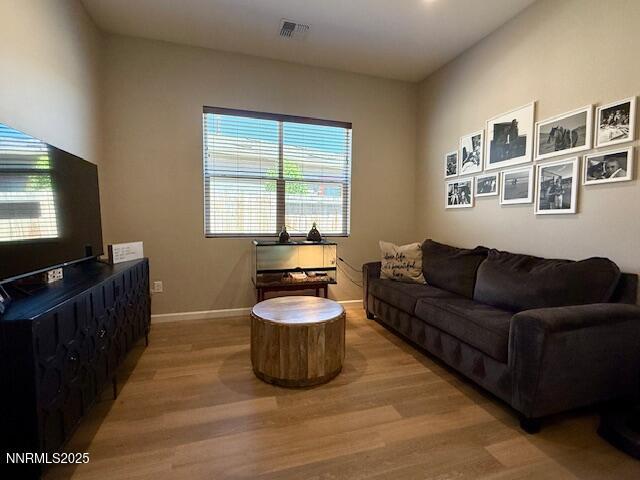7800 Hoback Dr, Sparks, NV 89436 - living room with light wood-style floors, healthy amount of natural light, and baseboards