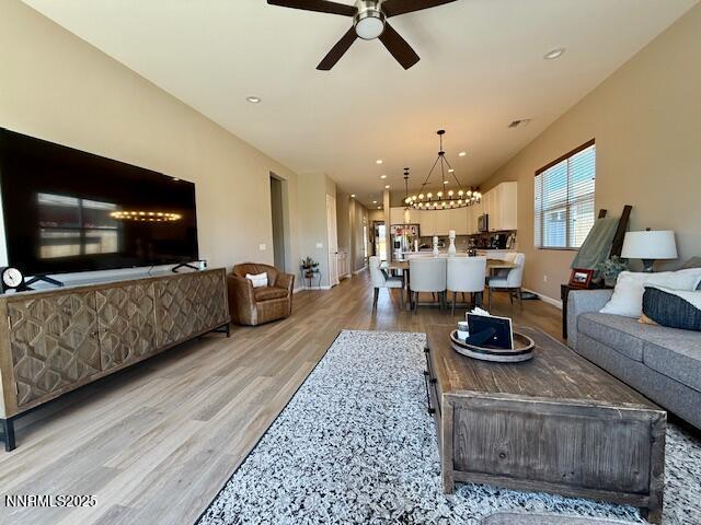 7800 Hoback Dr, Sparks, NV 89436 - living room featuring light wood-type flooring, ceiling fan, a chandelier, and recessed lighting