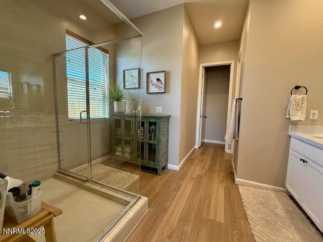 7800 Hoback Dr, Sparks, NV 89436 - bathroom featuring wood finished floors, vanity, a shower stall, and baseboards