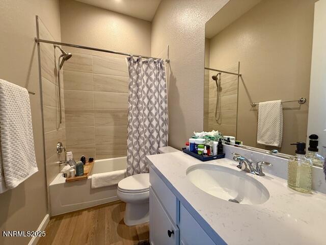 7800 Hoback Dr, Sparks, NV 89436 - full bathroom with shower / bathtub combination with curtain, vanity, toilet, and wood finished floors