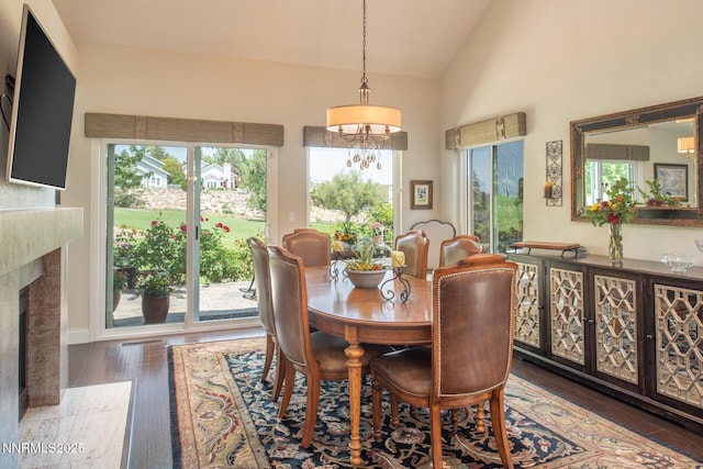 2061 Mountain Vista Way, Reno, NV 89519 - dining room with vaulted ceiling, a chandelier, hardwood / wood-style flooring, and a high end fireplace