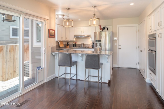 2061 Mountain Vista Way, Reno, NV 89519 - kitchen featuring stainless steel appliances, a peninsula, light stone counters, white cabinetry, and recessed lighting