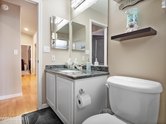 733 Bowles Ln, Gardnerville, NV 89460 - bathroom with wood finished floors, vanity, and toilet