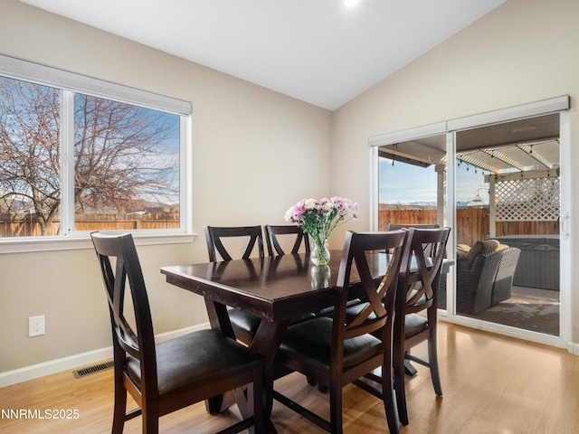 733 Bowles Ln, Gardnerville, NV 89460 - dining area with light wood-type flooring, healthy amount of natural light, vaulted ceiling, and baseboards