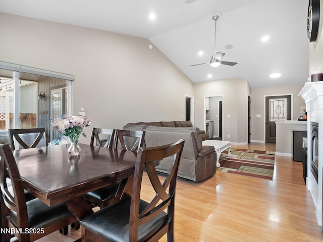 733 Bowles Ln, Gardnerville, NV 89460 - dining space featuring lofted ceiling, ceiling fan, light wood finished floors, a fireplace, and baseboards
