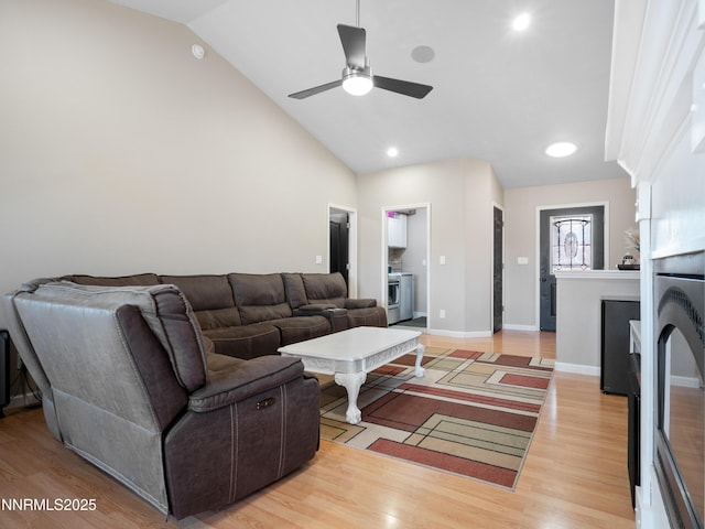 733 Bowles Ln, Gardnerville, NV 89460 - living room with lofted ceiling, light wood-style floors, ceiling fan, and baseboards