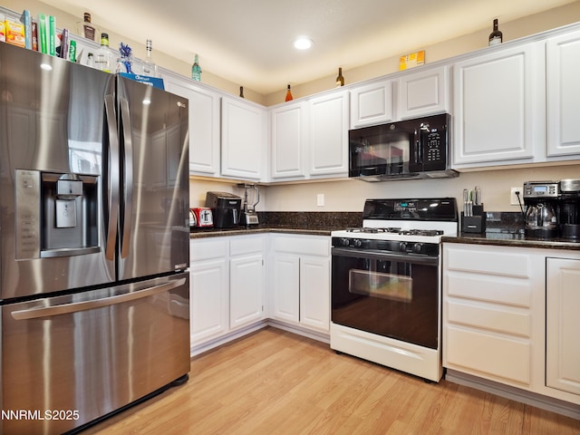 733 Bowles Ln, Gardnerville, NV 89460 - kitchen with stainless steel fridge with ice dispenser, gas range oven, black microwave, white cabinets, and recessed lighting