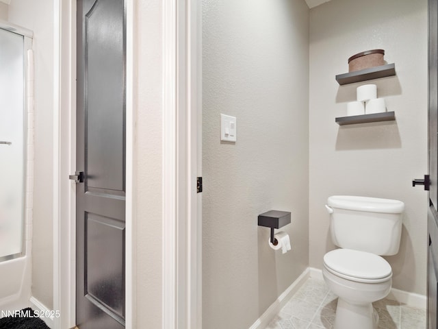733 Bowles Ln, Gardnerville, NV 89460 - full bathroom featuring toilet, a shower with shower door, baseboards, and tile patterned floors