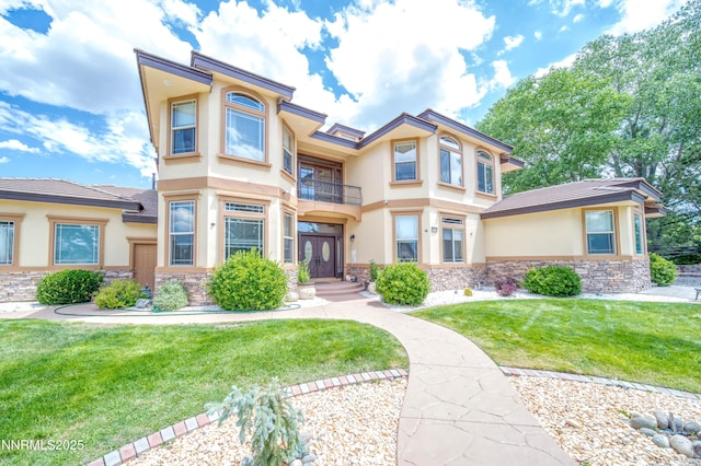 6752 Eagle Wing Cir, Sparks, NV 89436 - view of front of home with stucco siding, a balcony, stone siding, and a front lawn