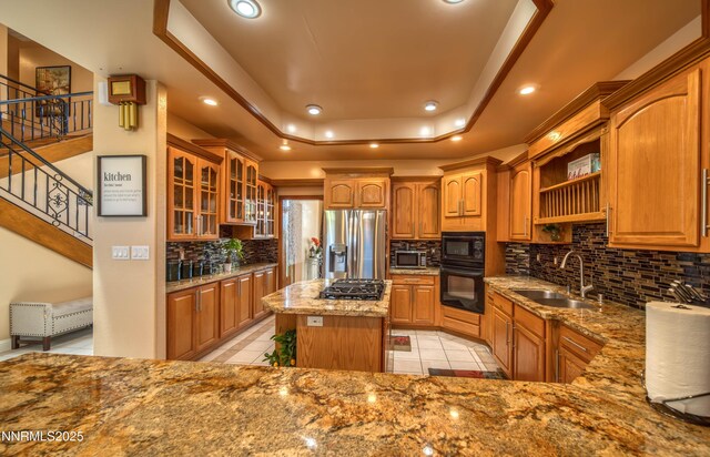 6752 Eagle Wing Cir, Sparks, NV 89436 - kitchen featuring black appliances, a raised ceiling, light stone countertops, decorative backsplash, and light tile patterned flooring